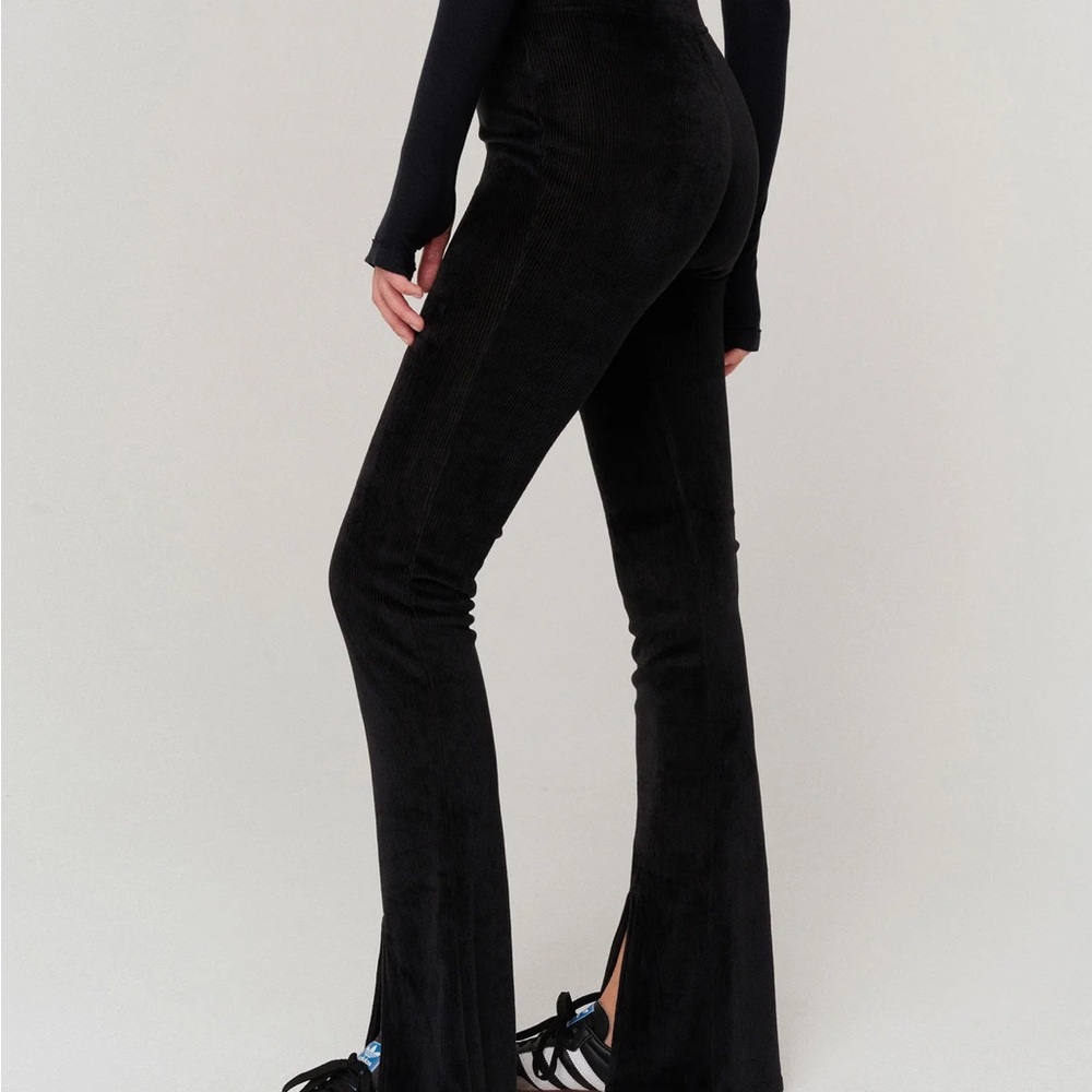 Chic black flared pants by NYLORA. Stylish and versatile for any wardrobe.